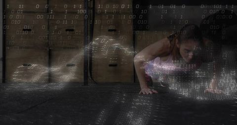 Mid-adult woman performing plank in industrial gym with binary code overlay, fitness tech concept