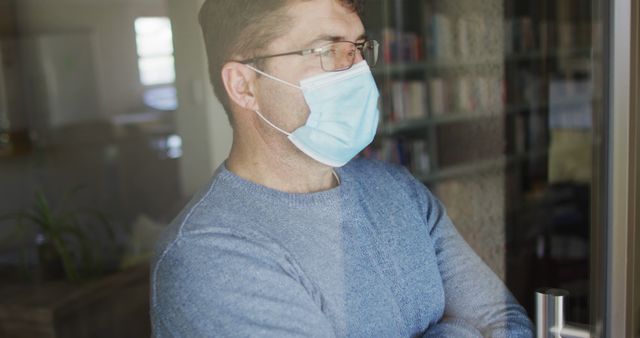 Man Wearing Face Mask Looking Through Window at Home - Download Free Stock Images Pikwizard.com