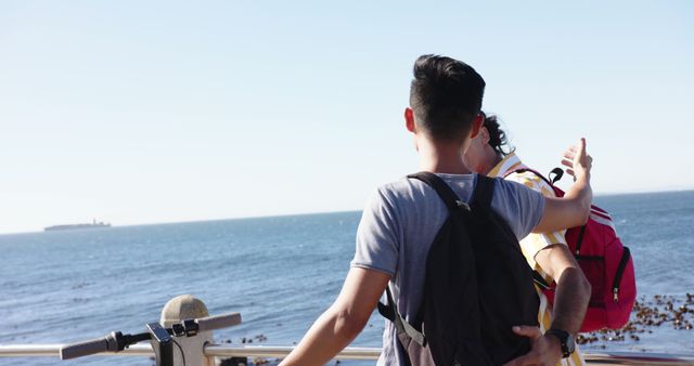 Back View of Friends Enjoying Scenic Ocean View with Backpack - Download Free Stock Images Pikwizard.com