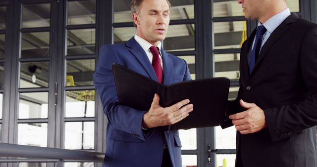 Corporate Businessmen Discussing Plans with Document Folder - Download Free Stock Images Pikwizard.com