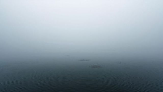 Minimal foggy seascape with gentle ripples and soft horizon gradient for calm design