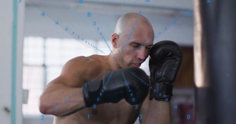 Shirtless boxer training with heavy bag and blue hud overlay showing strike trajectory