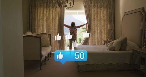 Senior woman opening curtains to scenic balcony view in elegant bedroom