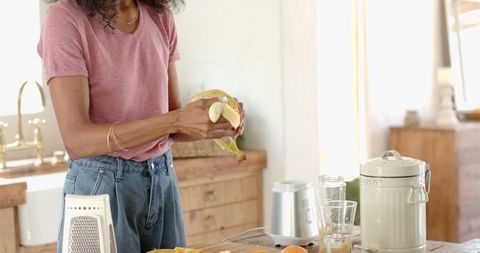 Woman Peeling Banana for Healthy Cooking in Rustic Kitchen