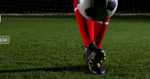 Soccer Player Balancing Ball on Turf at Night