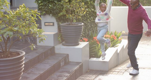 Father and Daughter Jumping with Joy in Front of Modern Home - Download Free Stock Images Pikwizard.com