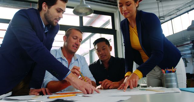 Diverse Business Team Collaborating on Project at Office Desk - Download Free Stock Images Pikwizard.com