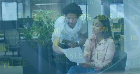 Diverse colleagues analyzing stock market data in office setting