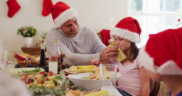 Family Enjoying Christmas Dinner Together with Festive Hats - Download Free Stock Images Pikwizard.com