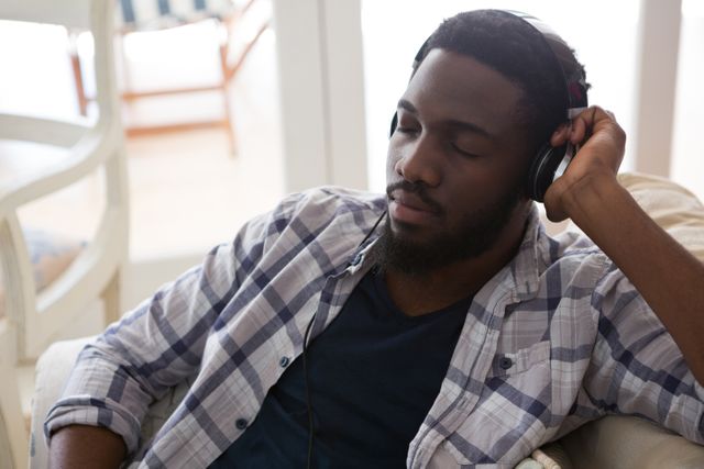 Man Relaxing with Headphones at Home - Download Free Stock Photos Pikwizard.com