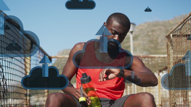 Showing dynamic technology use in fitness with overlay of cloud computing icons and an athlete checking his watch. This setting emphasizes the integration of technology in monitoring personal health and exercise data. Useful for themes including fitness apps, health technology, or lifestyle blogs, supporting promotion of new tech-savvy sports gear.