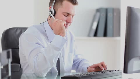 Customer Service Representative Using Headset in Office Environment