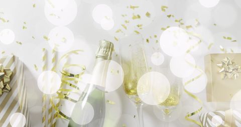 Festive New Year's Celebration with Champagne and Gold Confetti