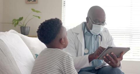 Pediatrician Examining Child With Digital Tablet in Modern Clinic - Download Free Stock Images Pikwizard.com