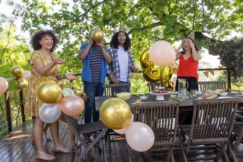 Diverse Friends Celebrating Outdoor Birthday with Balloons and Cake