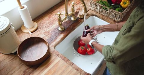 Washing Fresh Vegetables in Rustic Kitchen