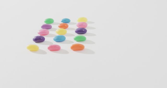 Vibrant, assorted jelly beans arranged neatly in a grid pattern on a plain white background. Ideal for use in advertisements, social media posts, or blog articles related to candy, baked goods, or children's parties. Can be used to convey themes of fun, playfulness, and sweetness.