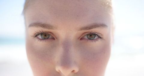Close-Up of Young Woman with Blue Eyes in Sunny Setting - Download Free Stock Images Pikwizard.com