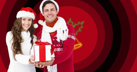 Cheerful Couple Sharing Gift at Christmas Celebration