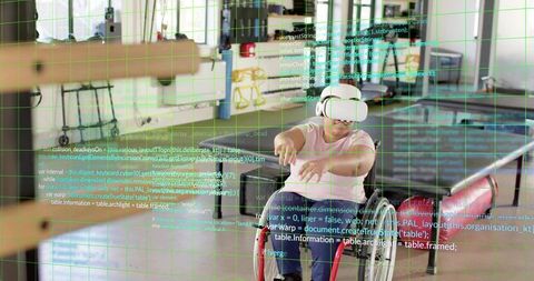 Empowering woman in wheelchair using vr headset in makerspace with assistive tech grid