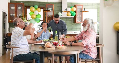 Senior Group Celebrating with Toast at Festive Dinner Gathering
