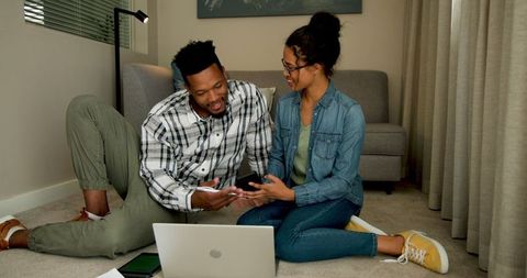 Couple Planning and Collaborating at Home Living Room Setting