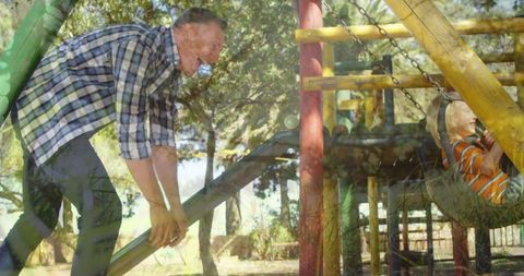 Father and Child Laughing as They Play on Playground Slide