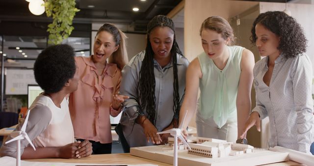 Diverse Female Team Collaborating on Architectural Model in Office - Download Free Stock Images Pikwizard.com