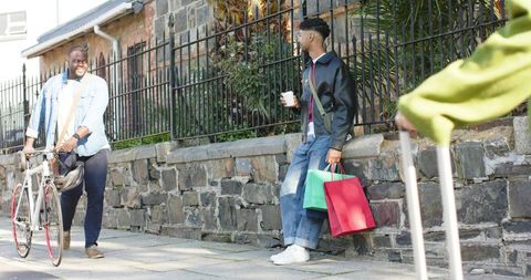 Sunlit Urban Meetup on Sidewalk with Bicycle, Coffee and Shopping Bags — Diverse Casual Commute