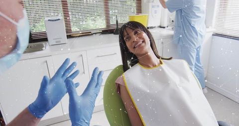 Patient talking with dentist in exam room setting