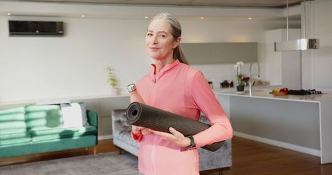 Senior Woman Embracing Wellness at Home With Yoga Gear