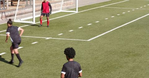 Soccer players activating penalty transition on sunny field
