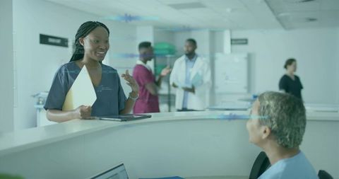 Nurse Collaborates at Hospital Reception Embracing Digital Tools