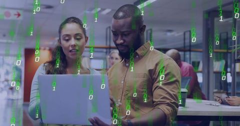 Team of diverse developers analyzing laptop with futuristic code overlay