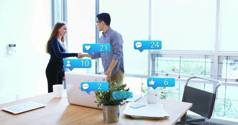 Young professionals shaking hands in modern office with social media notification overlays