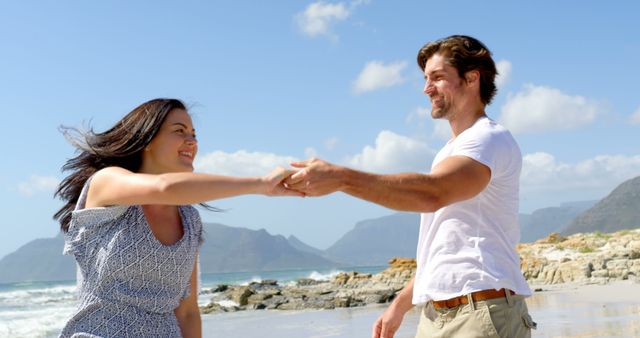 Happy caucasian couple holding hands on beach - Download Free Stock Photos Pikwizard.com