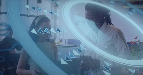 Business professionals using augmented reality tablet for collaborative planning in futuristic offic