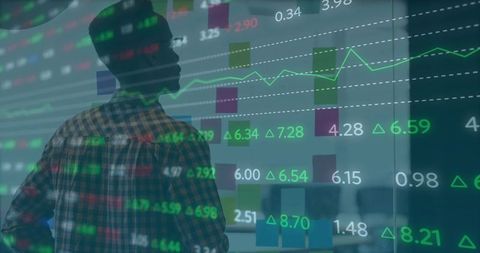 Analyst Reviewing Stock Charts on Transparent Display in Modern Office