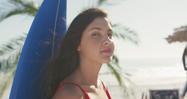 Confident Woman with Surfboard at Beach on Sunny Day - Download Free Stock Images Pikwizard.com