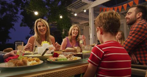 Caucasian parents, children and grandmother talking at family dinner table in garden, copy space - Download Free Stock Photos Pikwizard.com