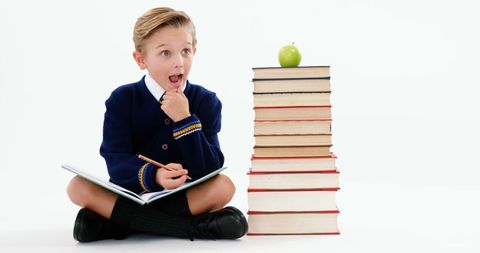 Young Boy in School Uniform Surprised While Reading Book - Download Free Stock Images Pikwizard.com