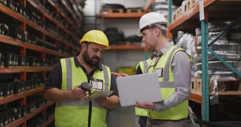 Caucasian Workers Overseeing Inventory in Industrial Warehouse - Download Free Stock Images Pikwizard.com