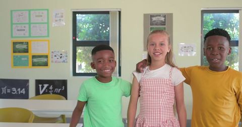 Smiling elementary students standing together in classroom showcasing friendship and diversity