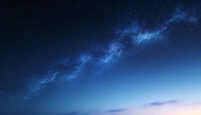 Glowing milky way stretching across deep twilight sky over calm distant horizon