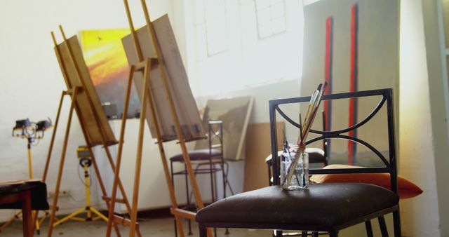 Sunlit Art Studio with Canvas, Easel, and Brushes - Download Free Stock Images Pikwizard.com