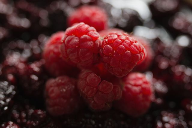 Close up of raspberries and blackberries on tart