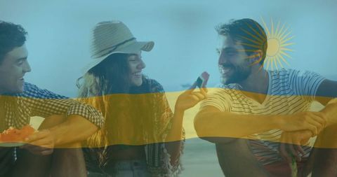 Summer leisure: friends enjoying a beach picnic with watermelon