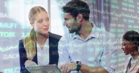 Team collaborating with digital stock charts in modern office