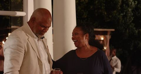 Senior couple enjoying garden evening celebration