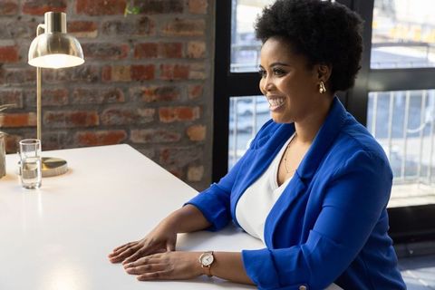 Confident Businesswoman Engaging at Workplace in Modern Office